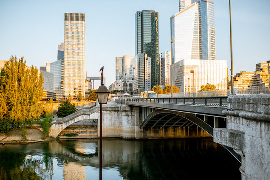 Cityscape view of La Defense financial district with skyscrapers and old bridge during the morning light in Paris