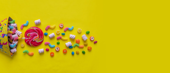Fototapeta na wymiar Candy caramel on a yellow background. Celebration.