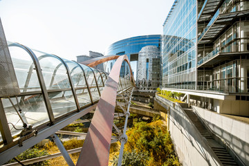 View on the modern pedestrian bridge in La Defense financial district in Paris