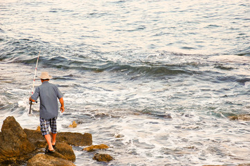 Fisherman on the beach and fisher boat sharing passion
