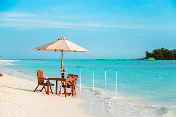 Beach table setup with turquoise water