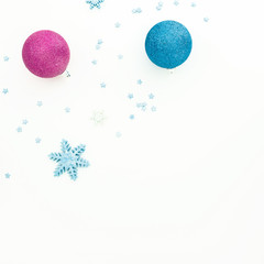 Creativity New Year composition. Christmas balls and blue decorations with copy space on white background. Flat lay, top view