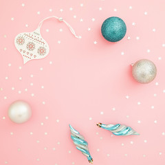 Christmas composition. Decoration and confetti on pink background. Flat lay, top view. Holidays concept