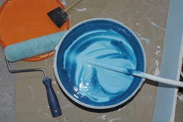 Painting tools for house renovation - rollers, blue paint, paint tray, sponge