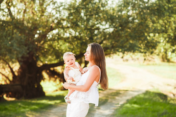 Happy mother and baby walking in city