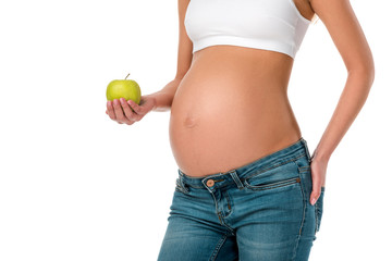 cropped view of pregnant woman holding green fresh apple isolated on white