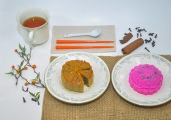 Mid autumn festival moon cake and hot tea isolated on white background. Chinese mid autumn festival food concept.