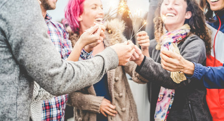 Fototapeta premium Group of friends celebrating with sparklers outdoor