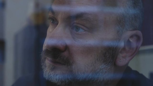 Lonely sad pensive bald man ath window. Loneliness,sadness