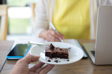 Business women are searching for information on their competitors with mobile phones to plan their future investments.concept