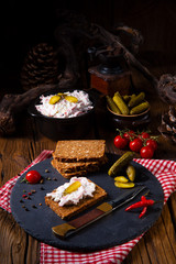 delicious spicy meat salad with cucumber on the black bread