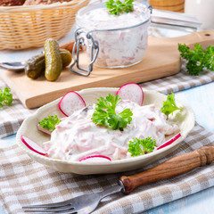 delicious homemade meat salad with mayonnaise and cucumber