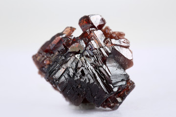 Uncut and rough deep red rhodolite garnet gemstone.