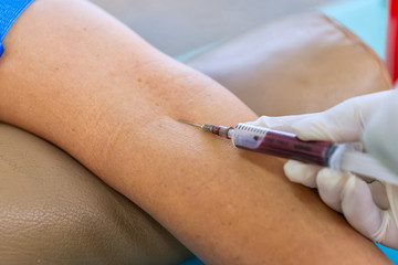 Nurse collecting a blood from patient in hospital