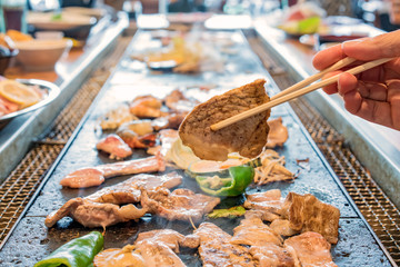 delicious grilled pork barbecue, meat are being cooked on stove