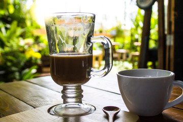 Eat coffee with morning tea on a wooden table. Garden decoration The sun is shining fresh.