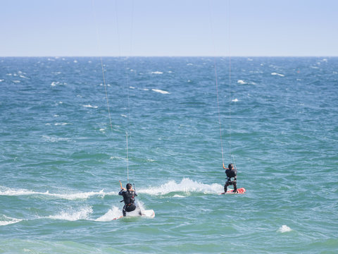 Kite surfers on blue waters of Atlantic Ocean in Portugal