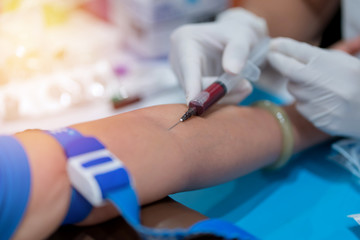 Nurse collecting a blood from patient in hospital