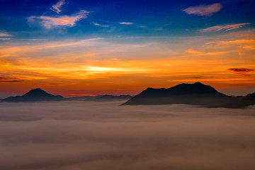 mountains under mist in the morning with sunrise at Phutoke Loei Thailand