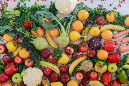 Rainbow colored fruits and vegetables on a white table. Juice and thanksgiving day concept.