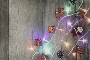 Colorful of Christmas lights on brown wooden floor.