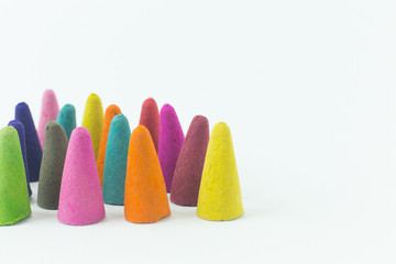 Incense Cone in a stand with the feather for background.