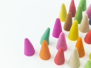 Incense Cone in a stand with the feather for background.