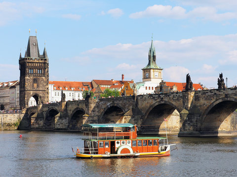 Old ship passes through Charles Bridge in Prague, Czech Republic. Vlatva River