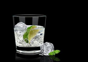 Vodka lime, mojito or gin tonic  with lime wedge and ice in rocks glass on black background including clipping path - obrazy, fototapety, plakaty