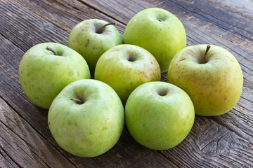 Organic apples on wooden background