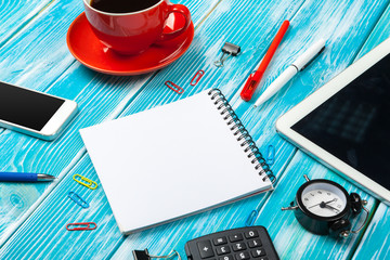 Modern workplace with cup of coffee on wooden table