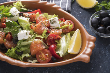 Salmon with vegetables,  cheese and  black olives in a plate.. Healthy food. Diet food