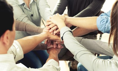 Group of people stacking hands