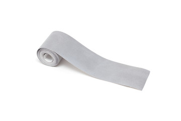 A roll of reflective tape on a white background, close-up, isolate, visibility, light reflection tape