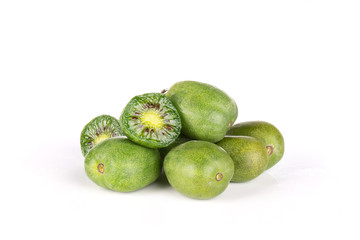 Stack of lot of whole two halves of fresh green mini baby kiwi fruit isolated on white background