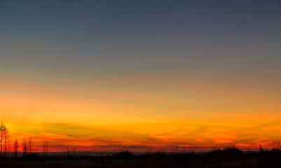 Bright colorful sunset over the field.