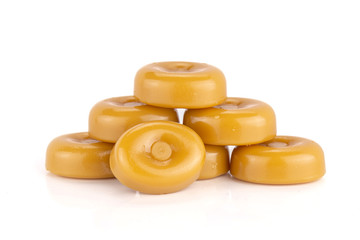 Group of seven whole hard caramel cream candy butterscotch variety isolated on white background