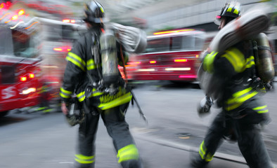 Fototapeta premium fire trucks and firefighters brigade in the city