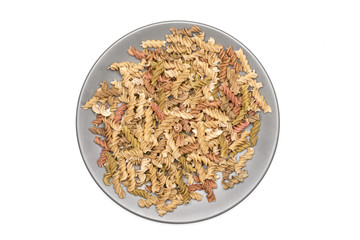 Raw pasta fusilli isolated on white