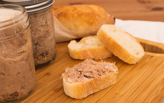 Homemade Rillettes French meat spread made of pork on baguette bread closeup