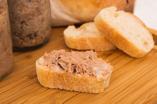 Homemade Rillettes French meat spread made of pork on baguette bread macro shot