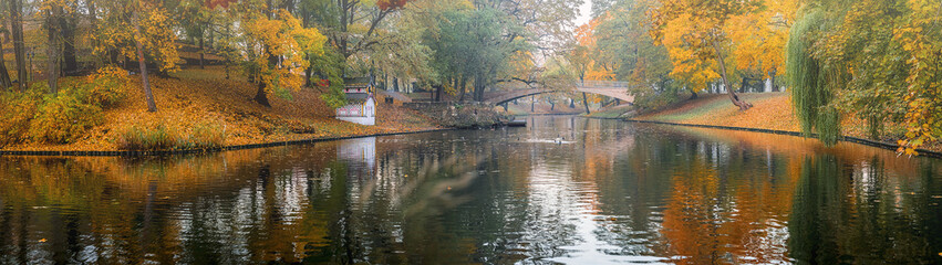 Fototapeta na wymiar Panorama. Autumnal morning in old city park, Riga, Latvia