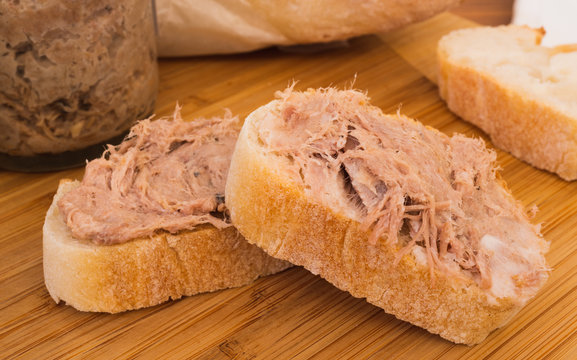 Two Homemade Rillettes French meat spread made of pork on baguette bread macro shot
