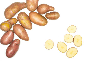 Group of lot of whole six slices of fresh red potato francelina variety flatlay isolated on white background