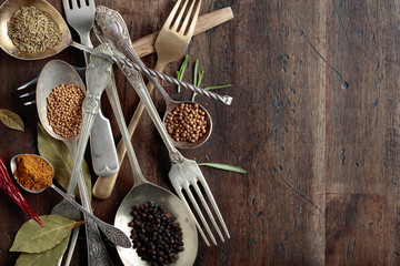 Various herbs and spices on wooden table.
