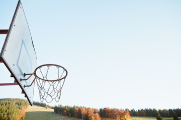 Old rusty chain basketball basket grunge with Autumn mountain hill background.jpg