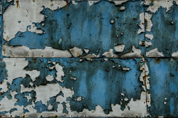 Vintage rusty blue background texture. Wall texture dirty pattern. The paint is falling apart, torn, broken, old and rusty. 