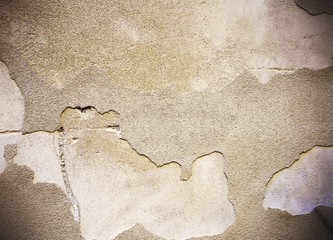 Damaged and peeled cement wall surface. Sepia tones. Useful for texture or background.