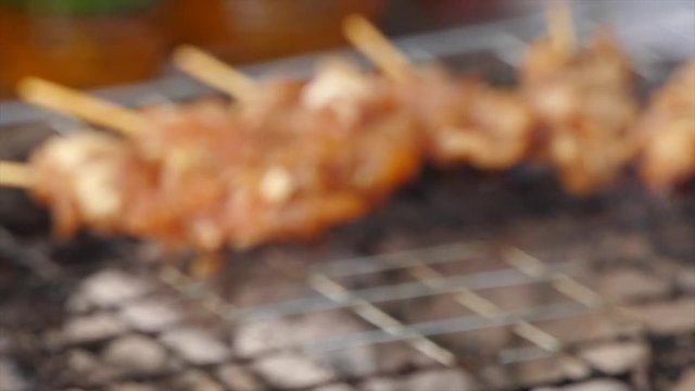Thai style BBQ pork fat are grilled on the  aluminium grid with wood charcoal  that some are burnt to grate. It is the most popular street food for Thai people especially  in the morning time.