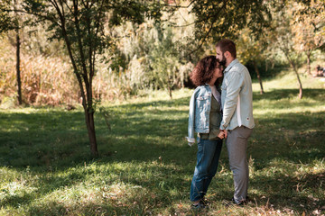 love, relationship, family and people concept - smiling couple hugging in autumn park